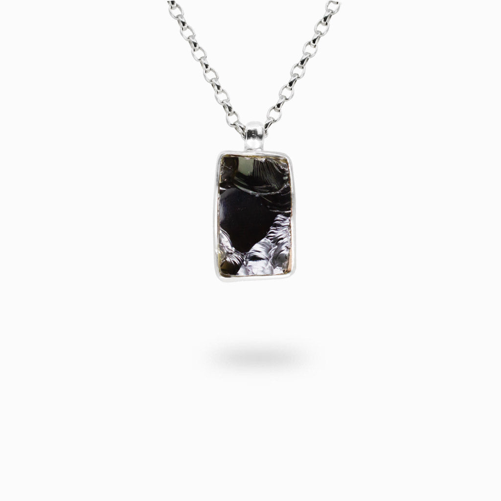 Rectangular Apache Tear Obsidian pendant with a polished dark translucent surface handcrafted in sterling silver.
