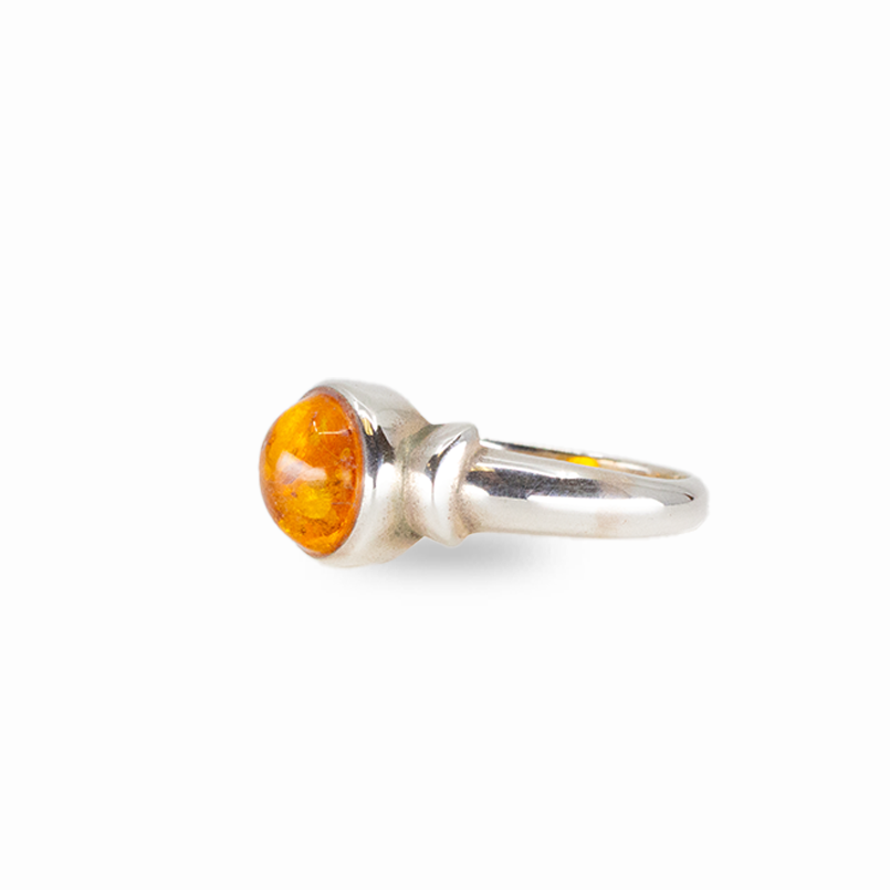 Round amber ring with warm golden fossilized resin set in sterling silver