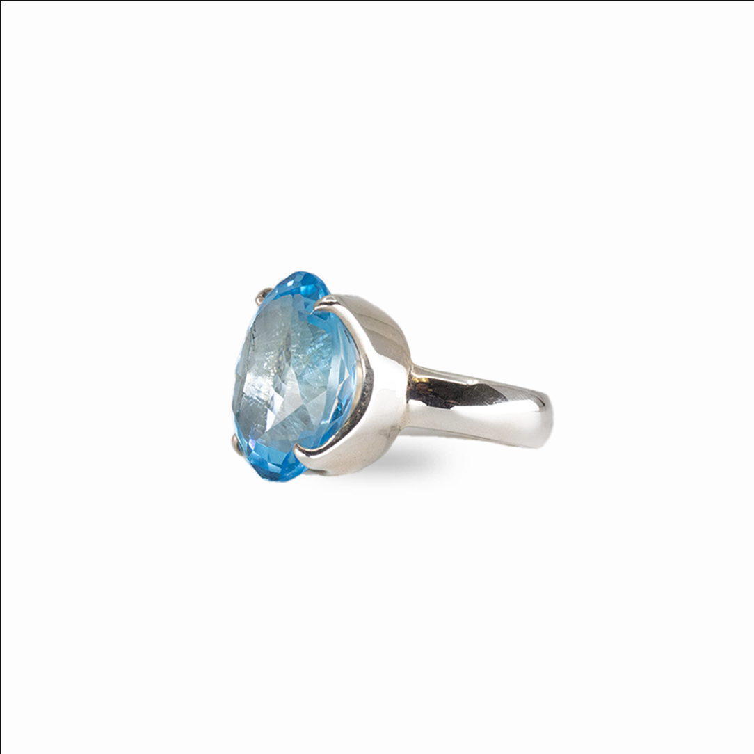 Oval blue topaz gemstone ring in sterling silver with brilliant electric blue color and prong setting