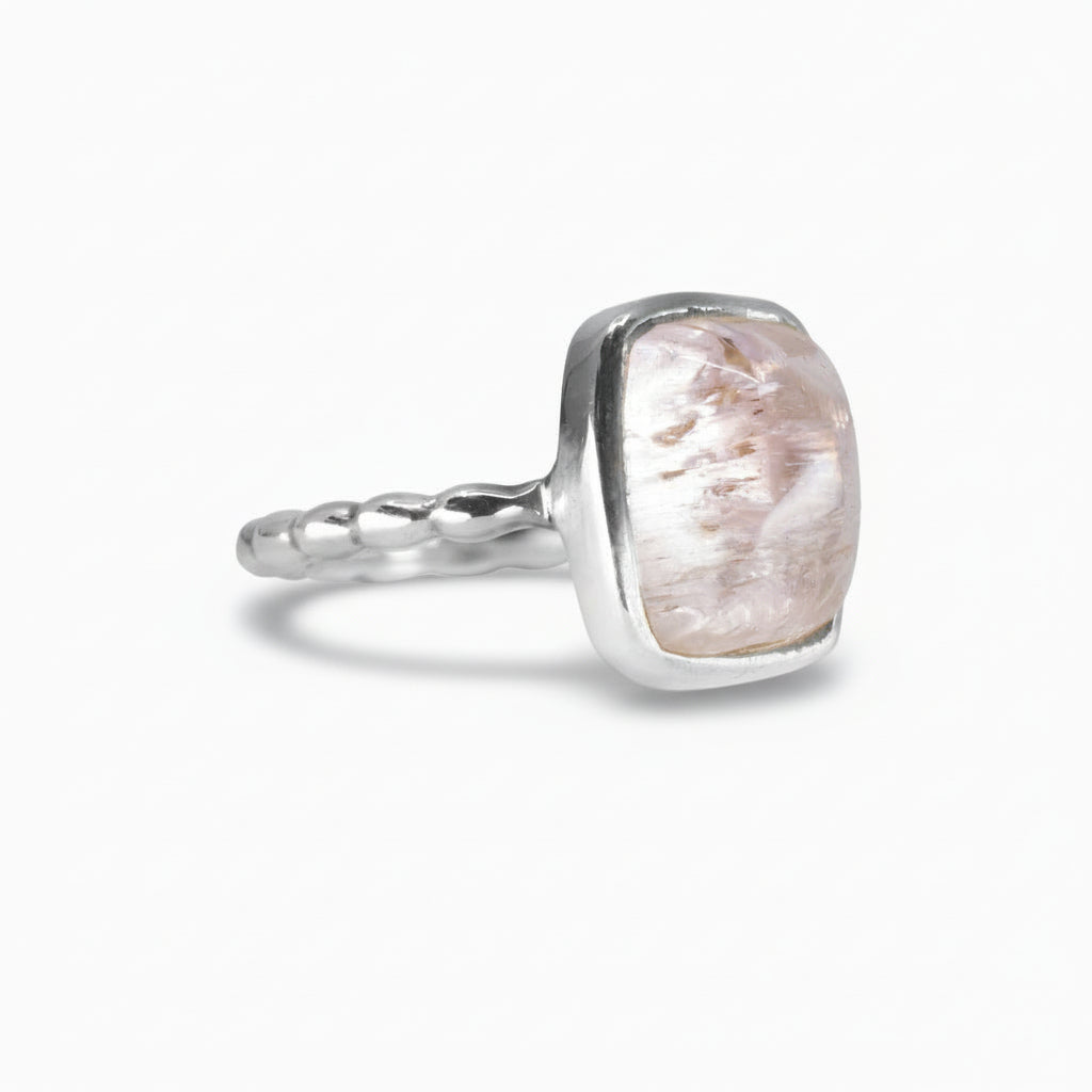 Rectangular soft pink Kunzite cabochon ring set in a polished sterling silver band with subtle texture, shown on a white background. | MADE IN EARTH