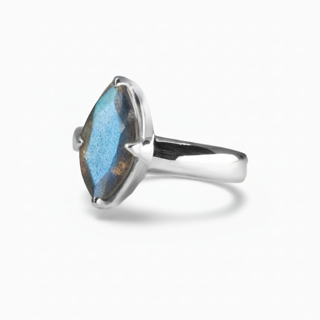 Marquise-cut faceted Labradorite ring with blue iridescent flashes set in polished sterling silver on a white background. | MADE IN EARTH