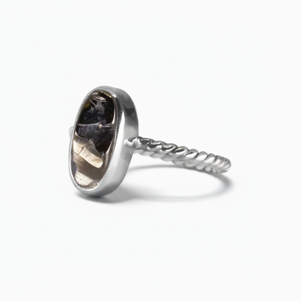 Oval polished Shungite ring set in a sterling silver textured band, featuring deep black reflective tones on a white background. | MADE IN EARTH