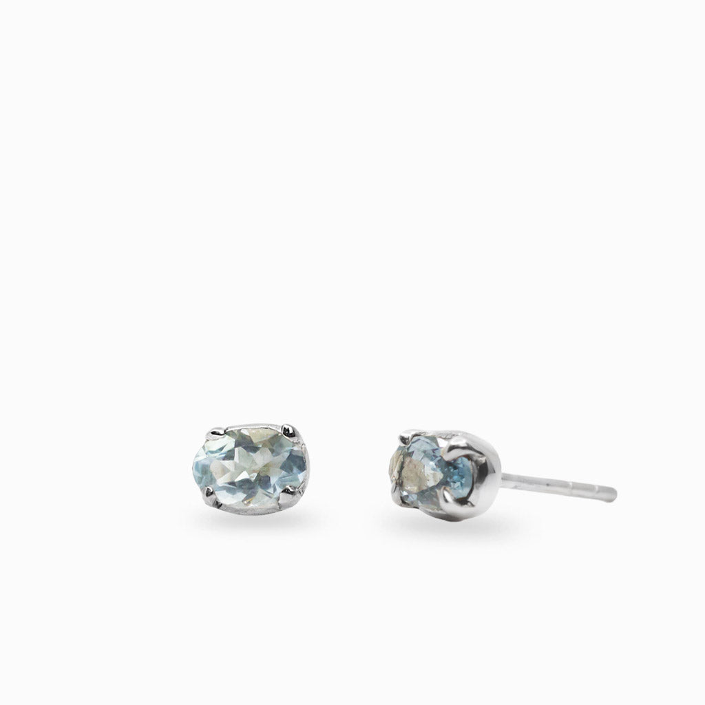 Aquamarine stud earrings set in sterling silver four-prong settings.
