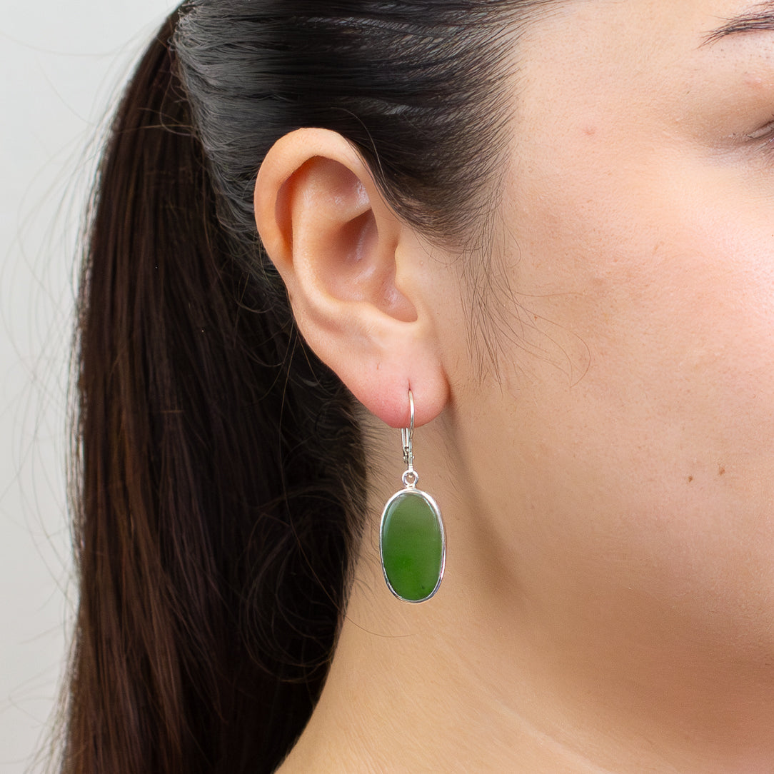 Oval nephrite jade cabochon earrings in deep green set in sterling silver with lever-back hooks. | MADE IN EARTH