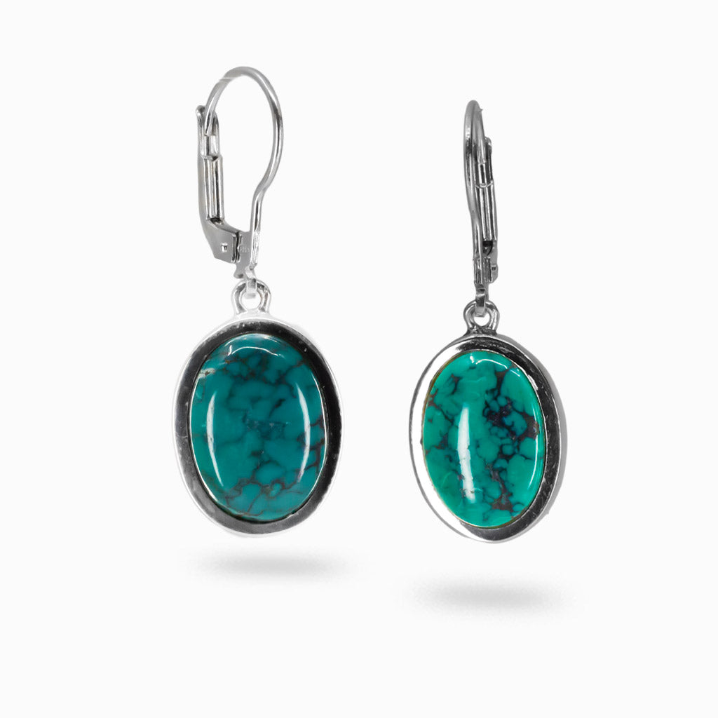 Tibetan turquoise cabochon drop earrings with blue-green stones and black matrix in sterling silver.