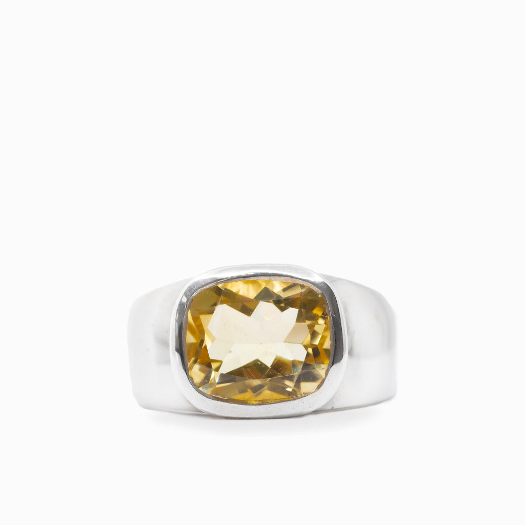 Cushion-shaped faceted golden Citrine gemstone set in a polished 925 sterling silver ring.