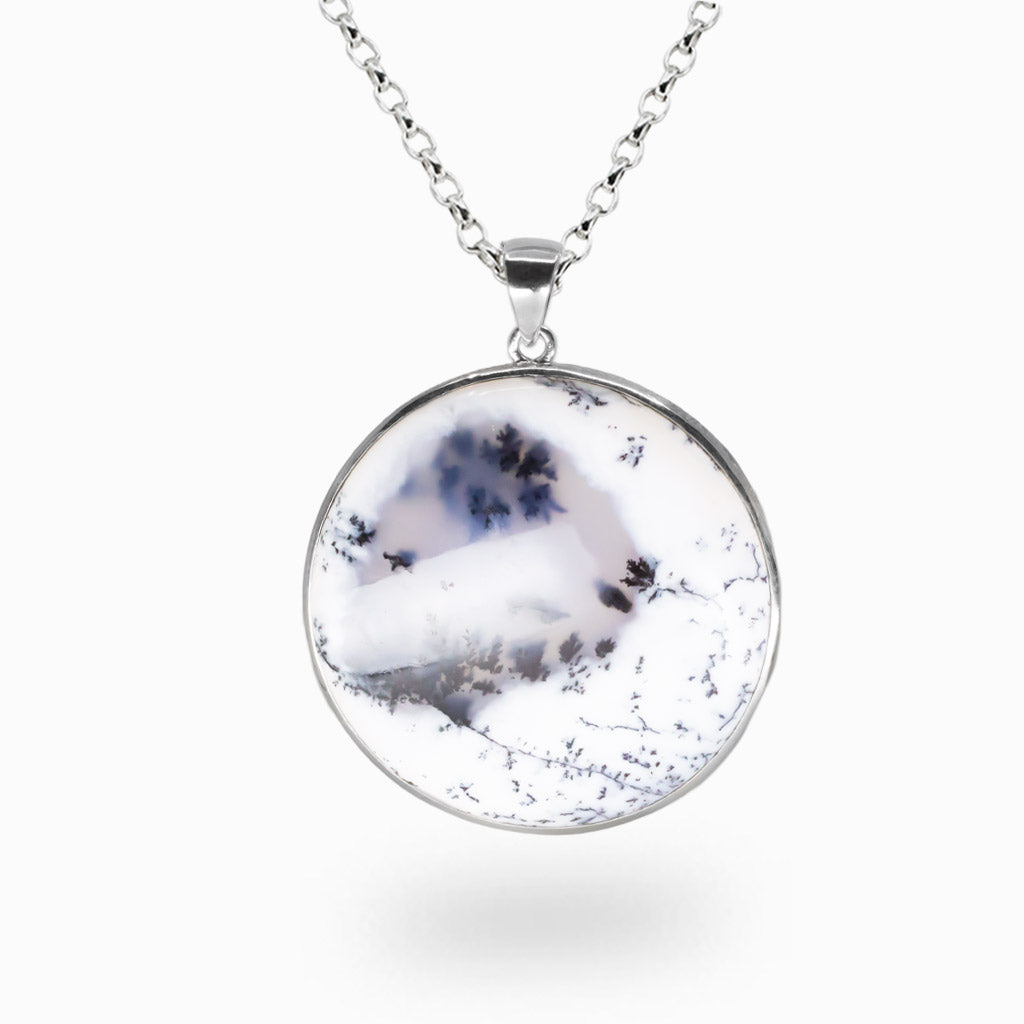 Round Dendritic Opal cabochon necklace with white body and black fern-like inclusions set in sterling silver. | MADE IN EARTH