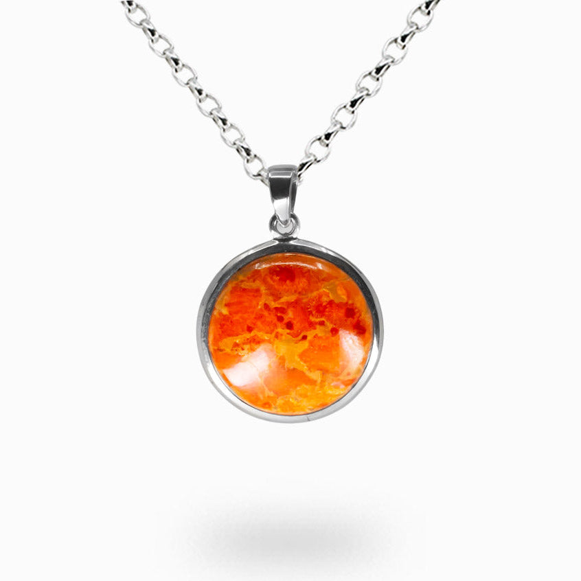 Round sponge coral cabochon pendant with vivid orange and red marbling set in sterling silver bezel on silver chain. | MADE IN EARTH