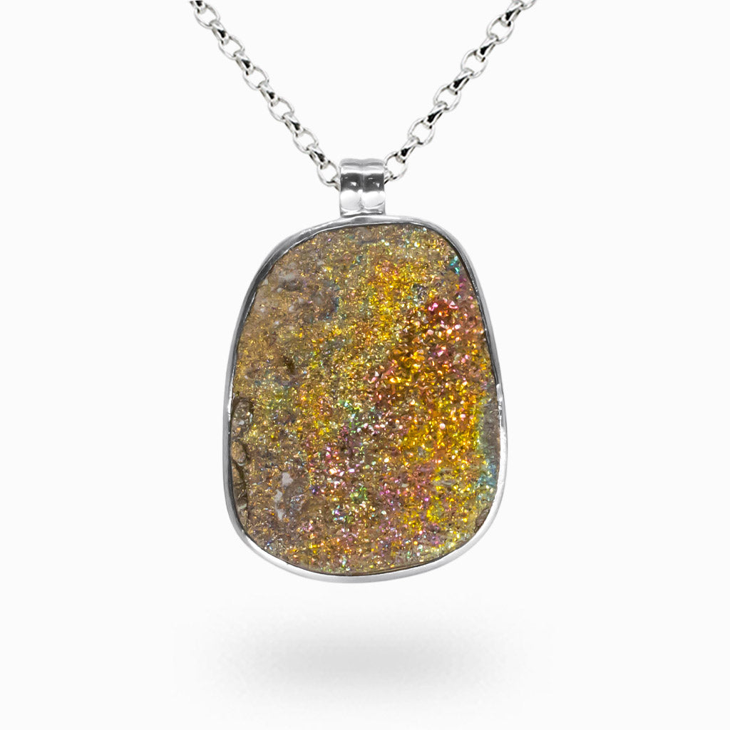 Raw rainbow pyrite druzy pendant with iridescent metallic crystals set in a sterling silver bezel on a silver chain.