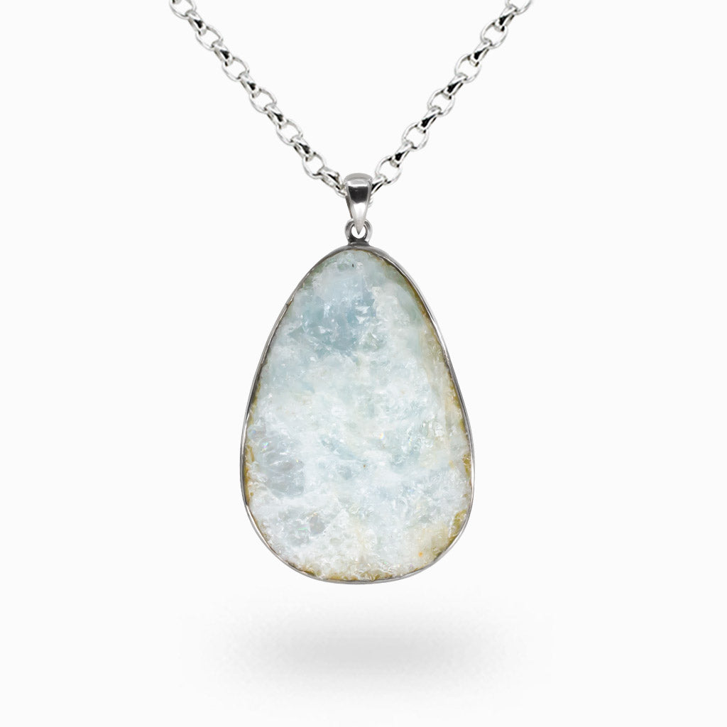 Raw aquamarine druzy crystal necklace set in sterling silver with natural icy blue crystal formations. | MADE IN EARTH