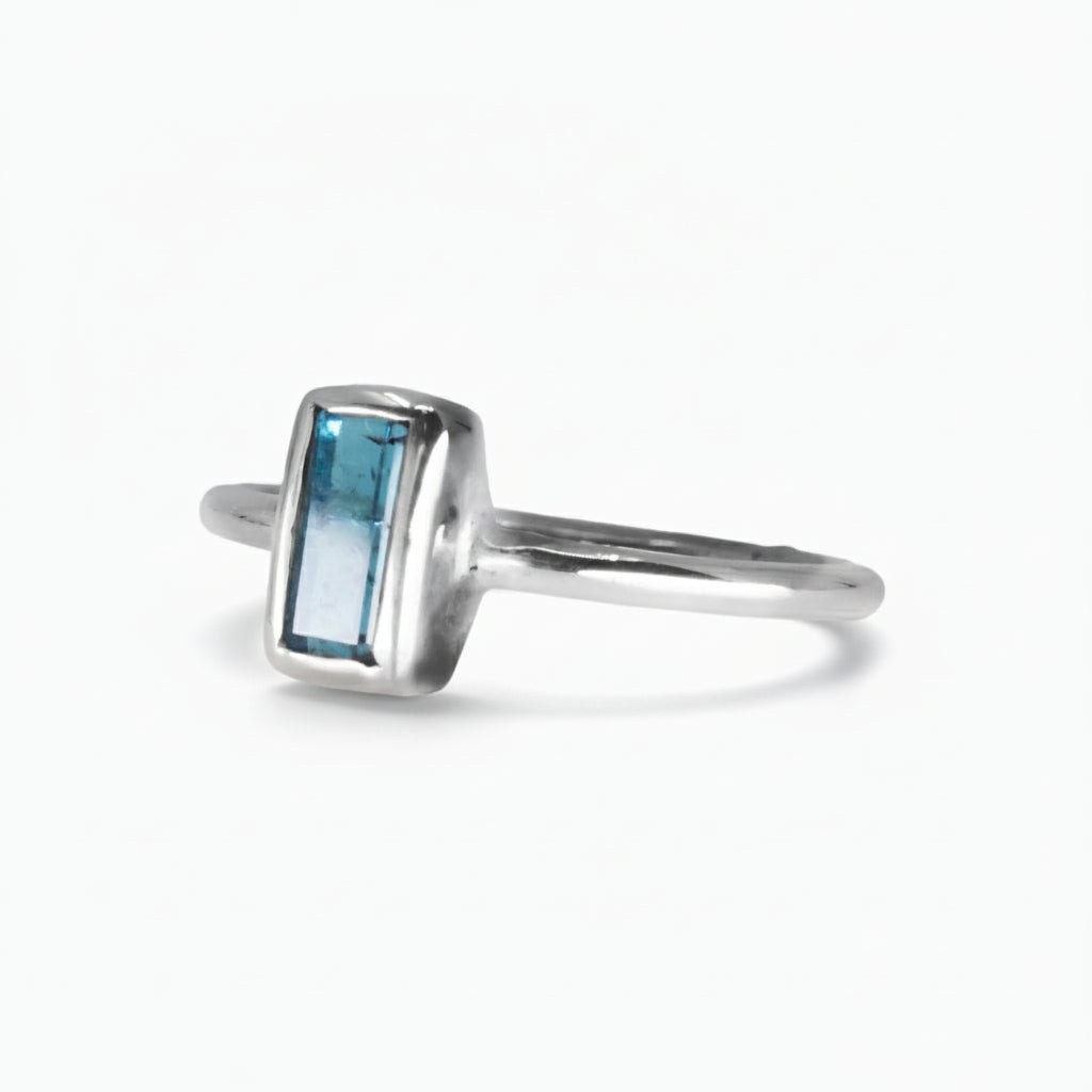 Faceted rectangle blue tourmaline ring in a silver bezel setting on a thin sterling silver band | MADE IN EARTH