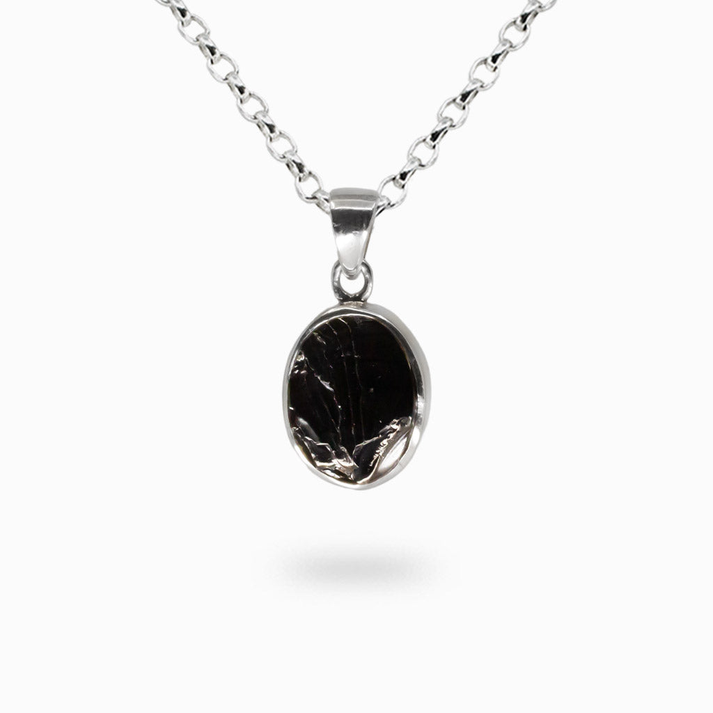 Raw oval shungite gemstone pendant set in sterling silver bezel necklace.