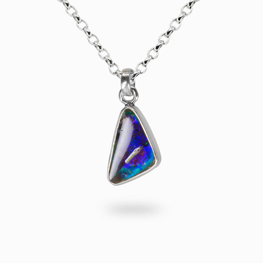 Triangle cabochon ammolite gemstone pendant set in sterling silver bezel.
