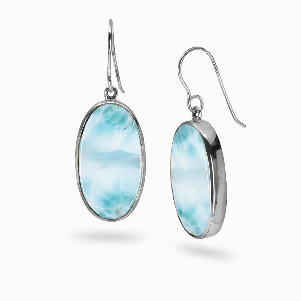 Oval Larimar gemstone drop earrings in sterling silver featuring soft ocean-blue patterns and a polished cabochon finish. | MADE IN EARTH