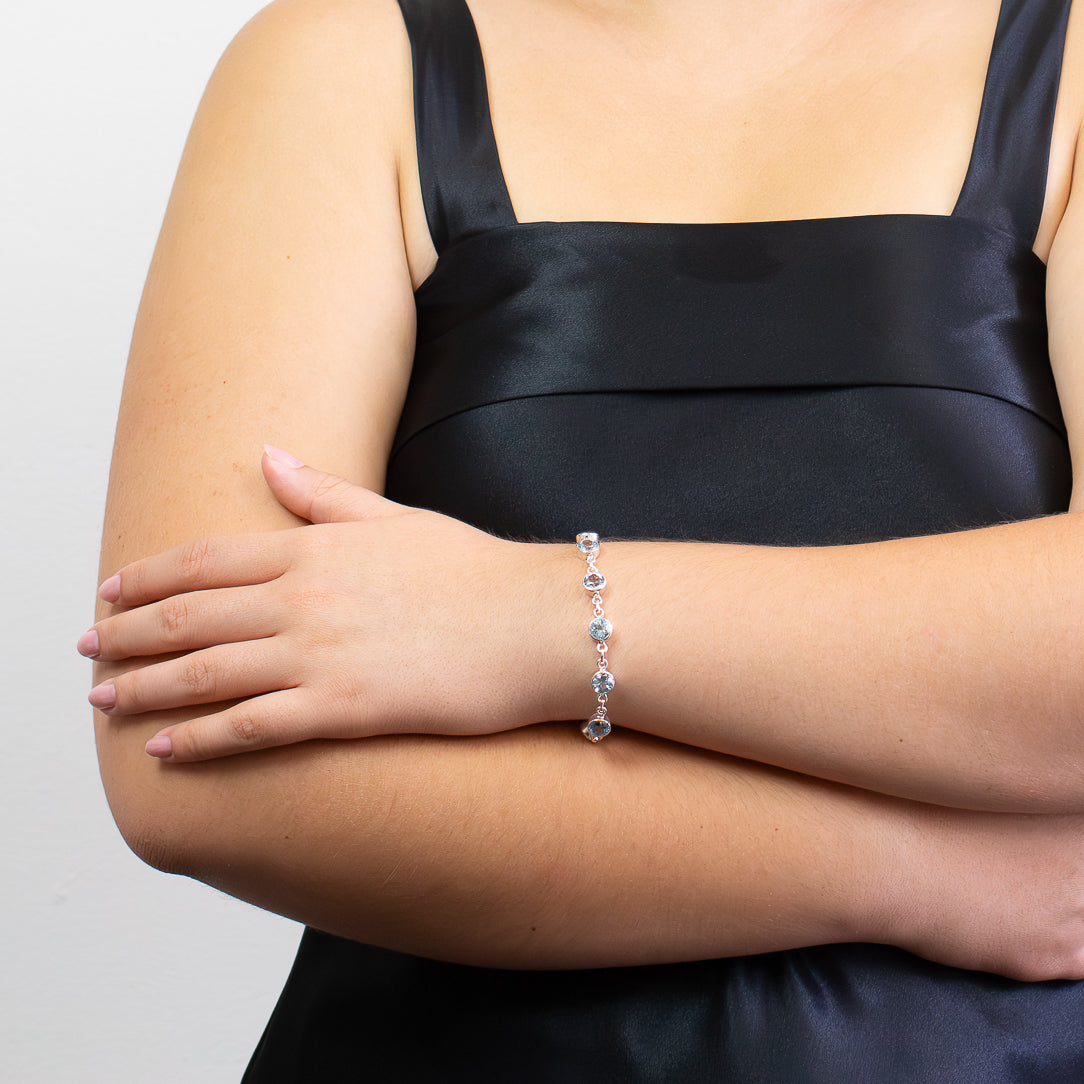 Faceted Blue Topaz bracelet in sterling silver with round blue gemstones.