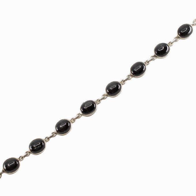 Black Star Diopside bracelet in sterling silver with oval cabochon gemstones.