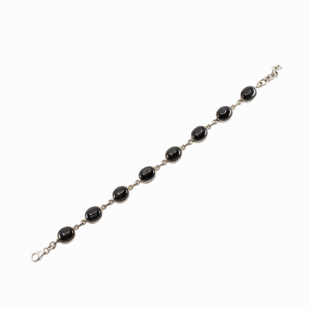 Black Star Diopside bracelet in sterling silver with oval cabochon gemstones.