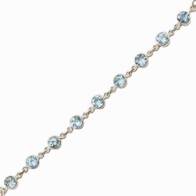 Faceted Blue Topaz bracelet in sterling silver with round blue gemstones.
