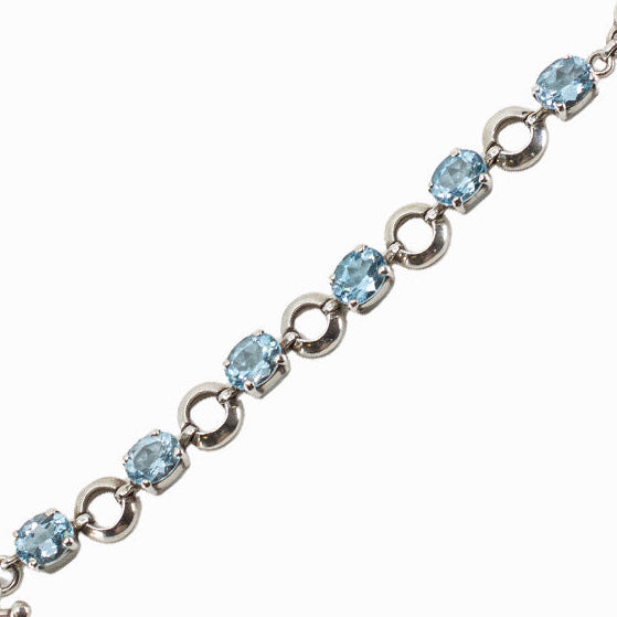 Blue Topaz sterling silver link bracelet with faceted oval gemstones.
