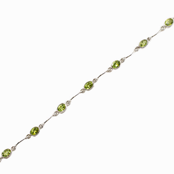 Faceted Peridot bracelet in sterling silver with oval green gemstones.
