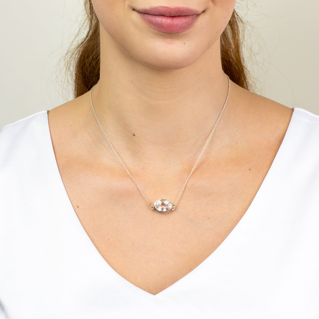 Faceted Clear Quartz oval necklace in sterling silver bezel setting.