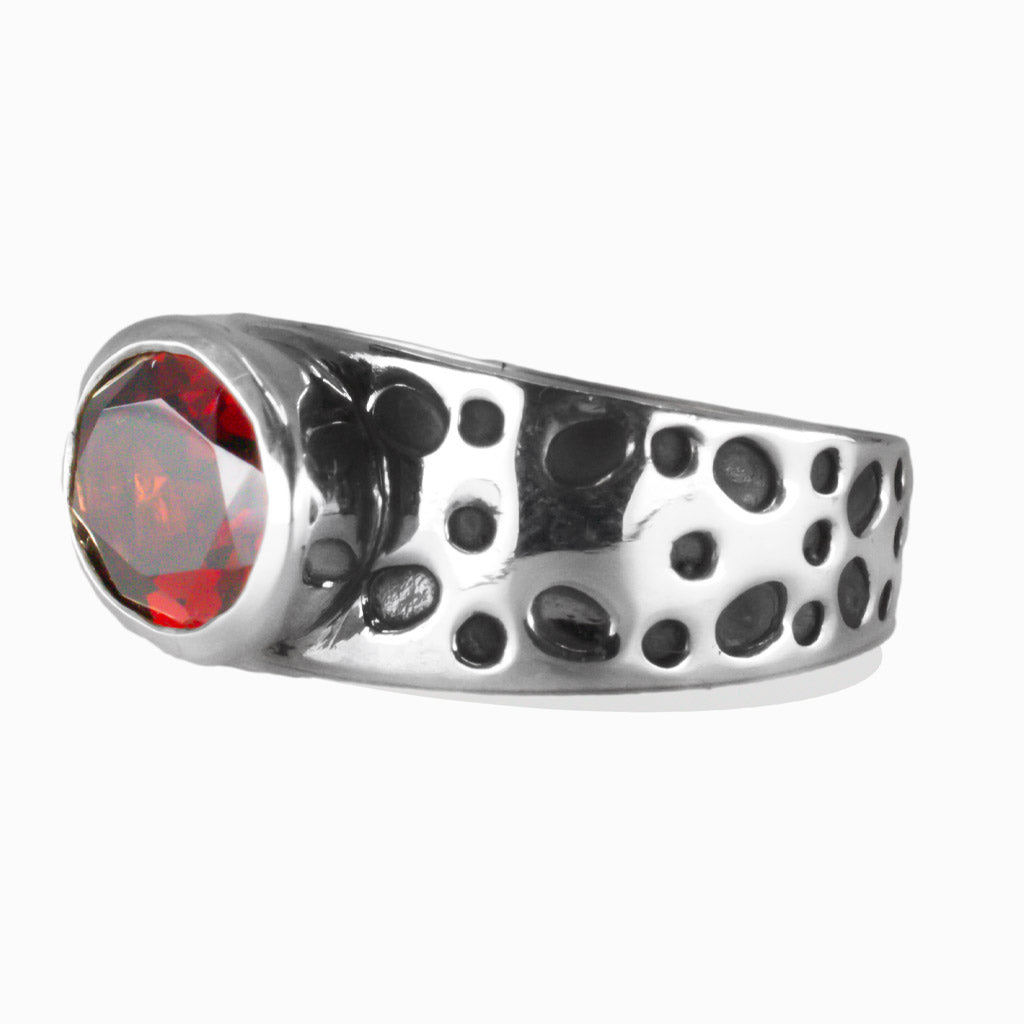Faceted oval Garnet ring with textured sterling silver band, deep red gemstone with rich shine. | MADE IN EARTH