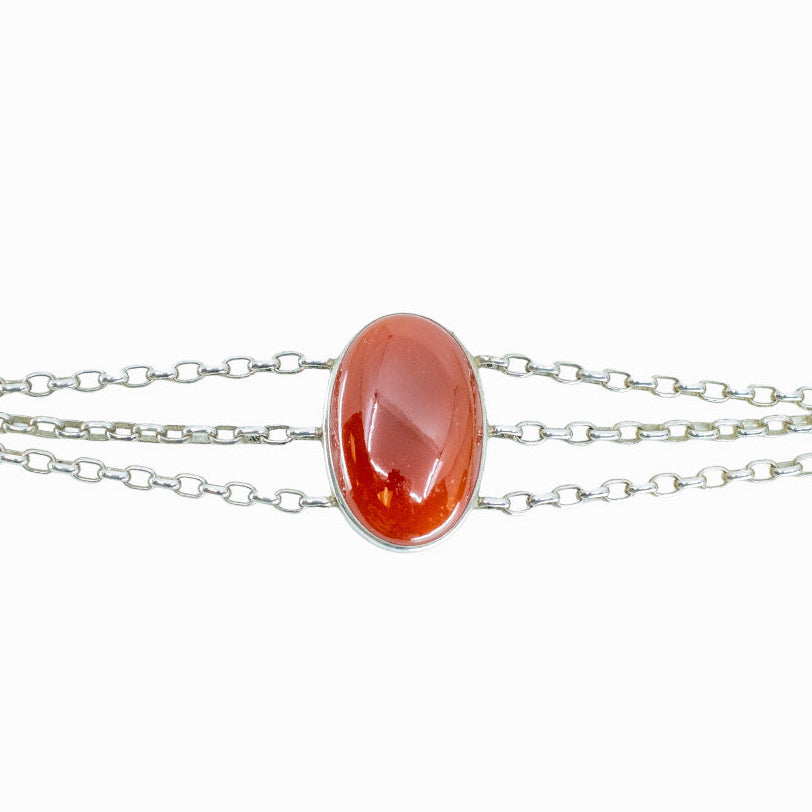 Carnelian oval cabochon bracelet in sterling silver with warm orange gemstone.