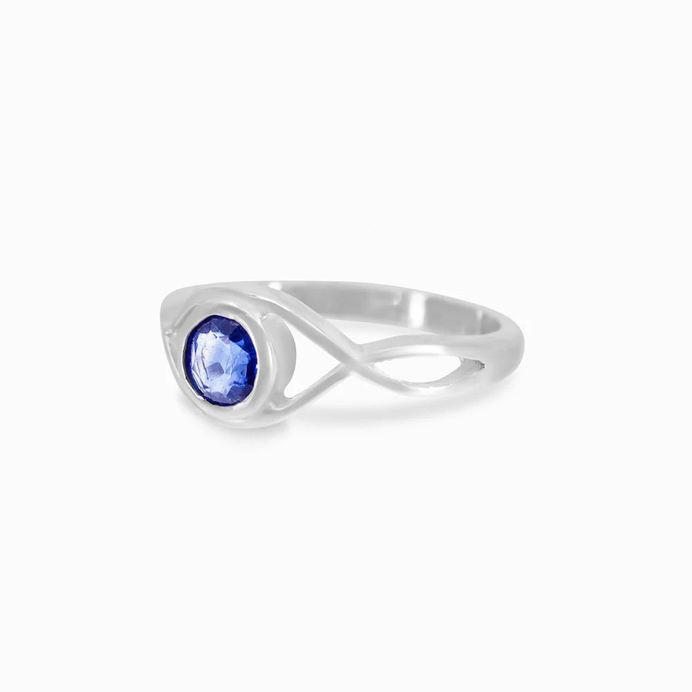 Round faceted deep blue Kyanite gemstone in polished sterling silver eye design ring.