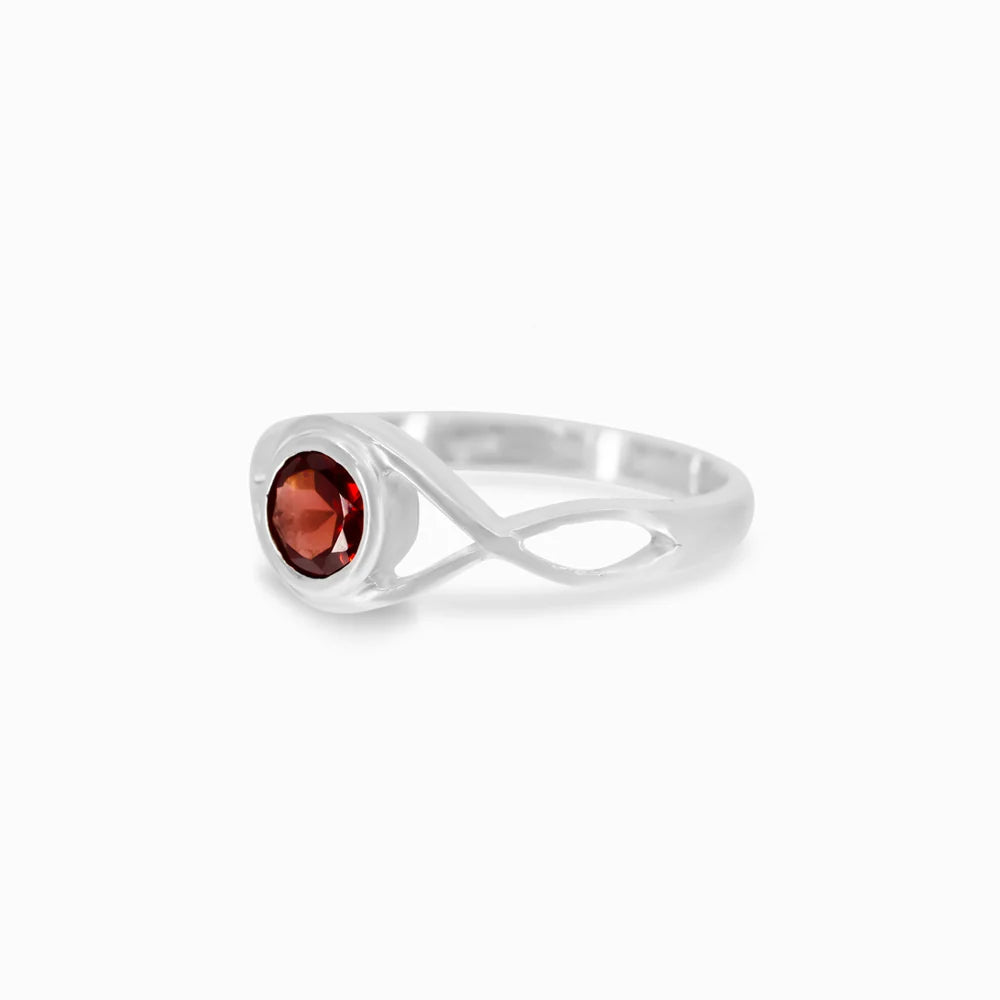 Round faceted deep red Garnet gemstone in polished sterling silver eye design ring.