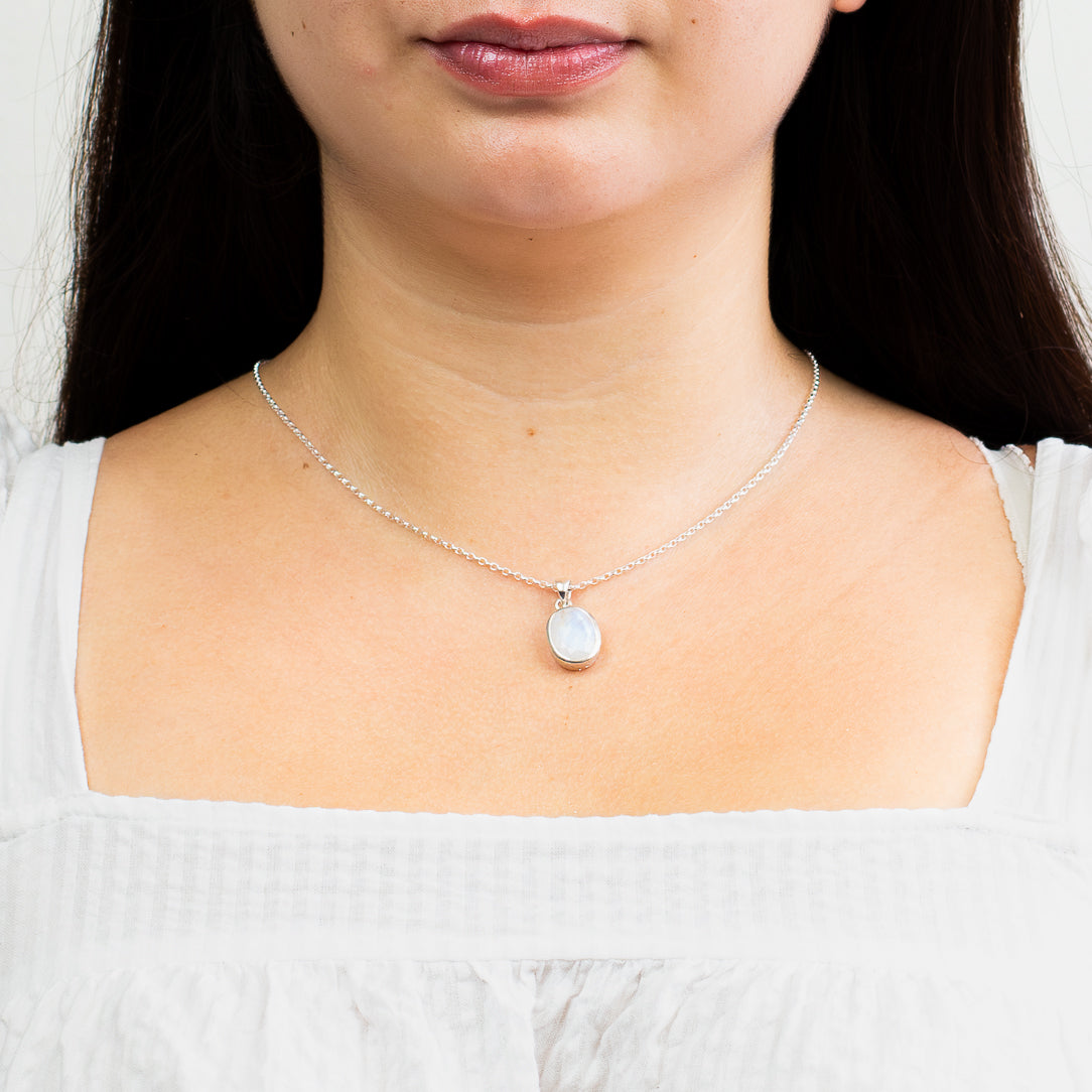 faceted rainbow moonstone necklace in sterling silver bezel on model