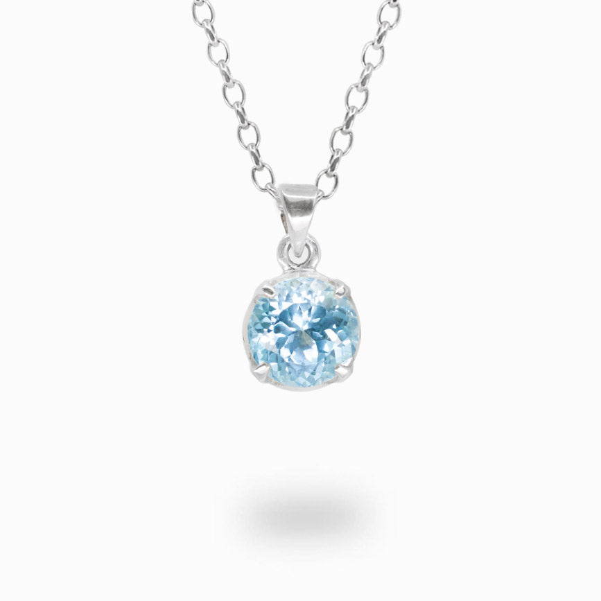 Faceted round blue topaz pendant necklace in sterling silver