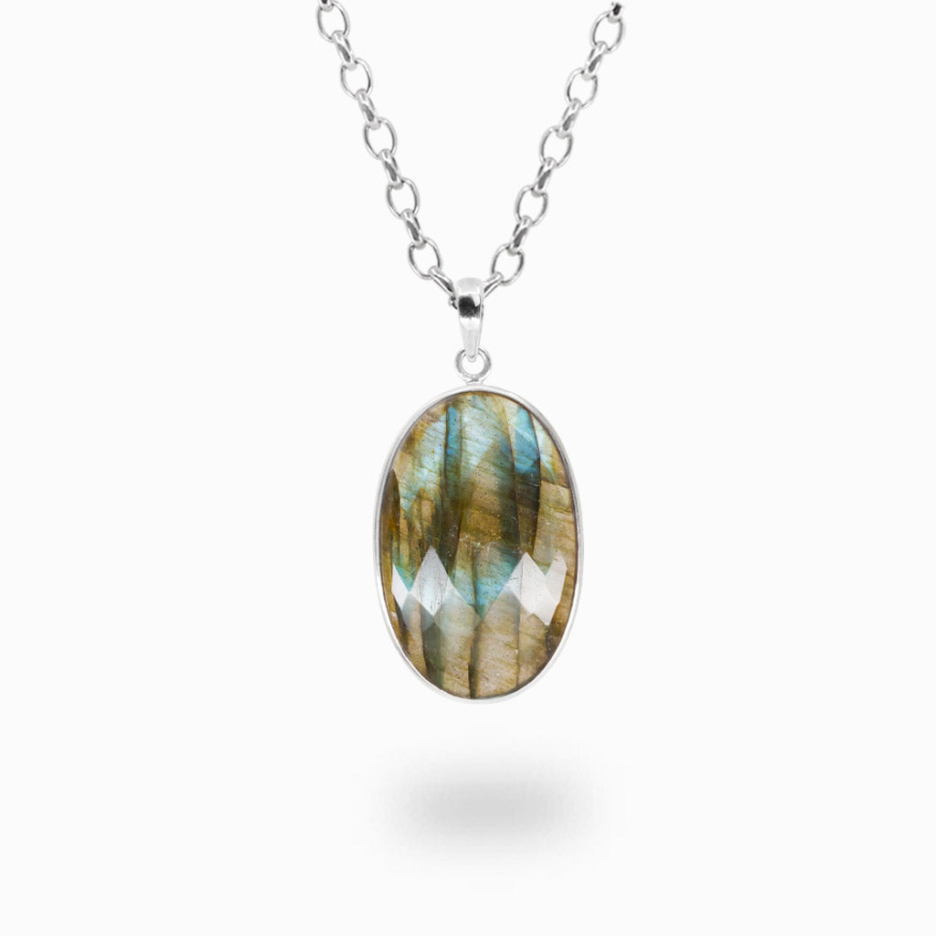 Faceted oval Labradorite pendant necklace in sterling silver displaying natural blue and gold iridescent flashes.