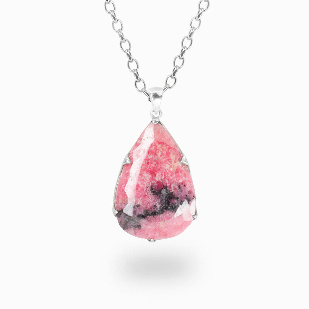 Faceted tear-shaped Rhodonite pendant necklace in sterling silver featuring vibrant pink gemstone with natural black veining.