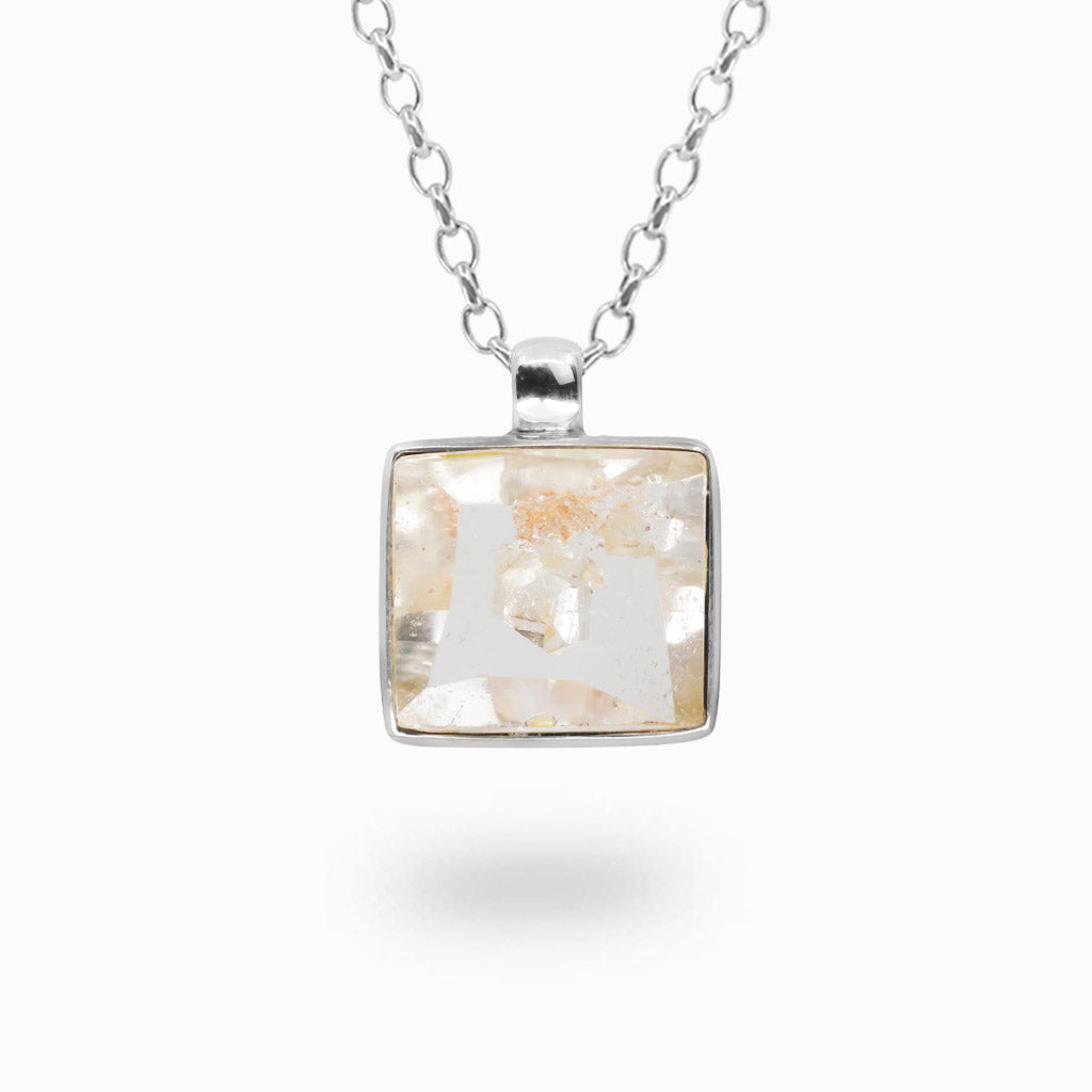 Faceted Manifestation Quartz necklace in sterling silver. Natural crystal pendant featuring unique internal inclusions.