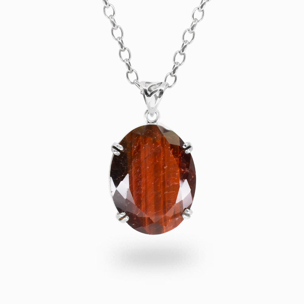 Faceted oval Red Tiger Eye pendant necklace in sterling silver featuring deep red chatoyant gemstone.