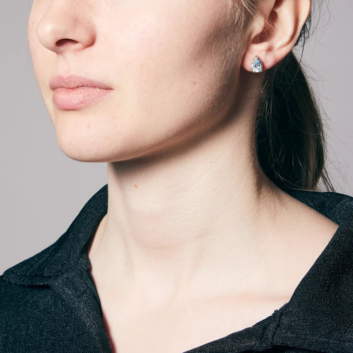 Teardrop faceted Blue Topaz gemstones prong set in polished sterling silver stud earrings.