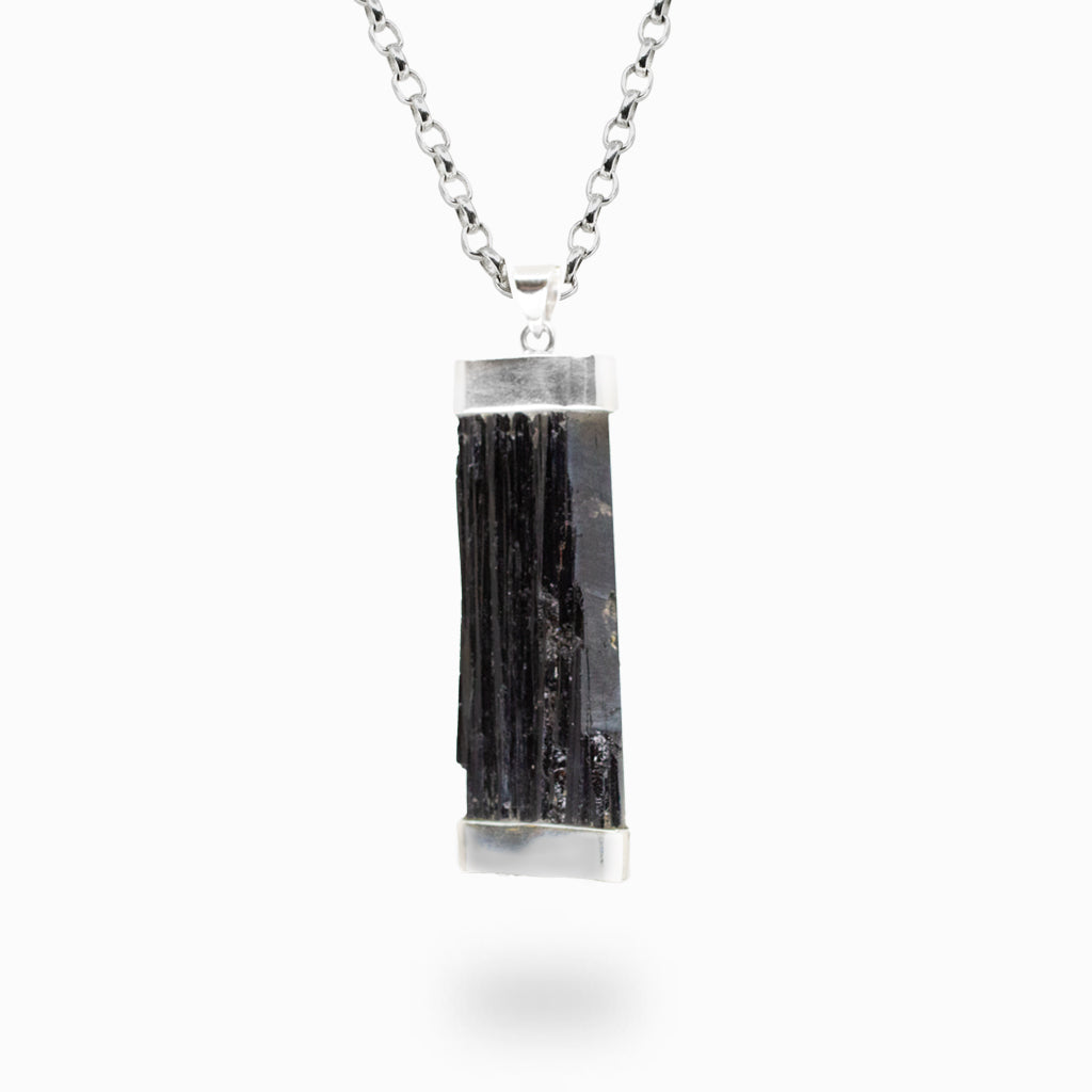 Raw Black Tourmaline crystal pendant necklace in sterling silver featuring natural black mineral structure.