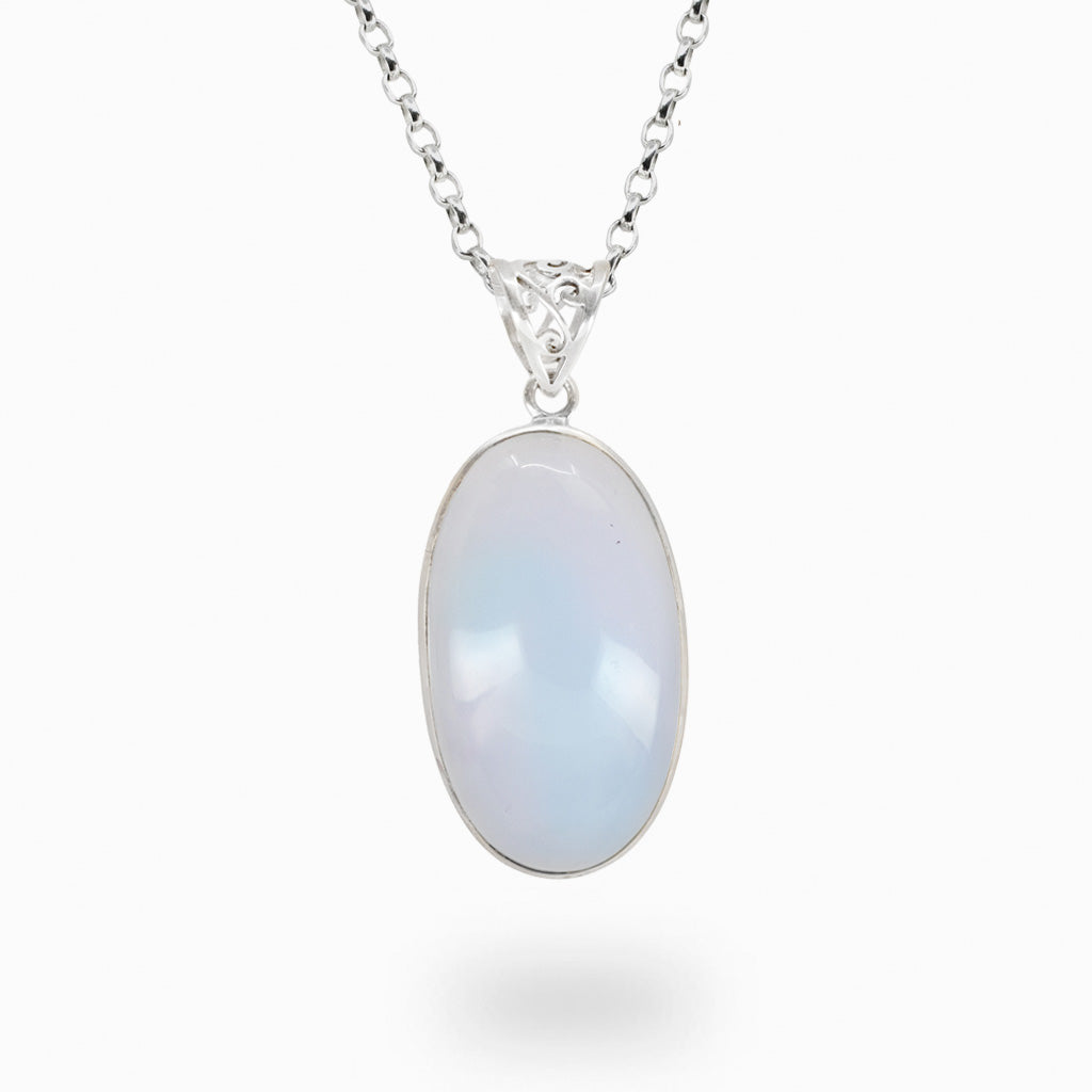 Oval Blue Chalcedony pendant necklace in sterling silver featuring pale blue translucent gemstone.