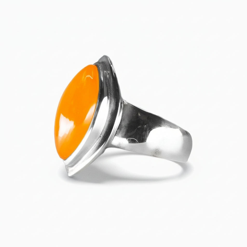 Marquise-cut orange Carnelian cabochon ring set in polished sterling silver with smooth, modern contours on a white background. | MADE IN EARTH