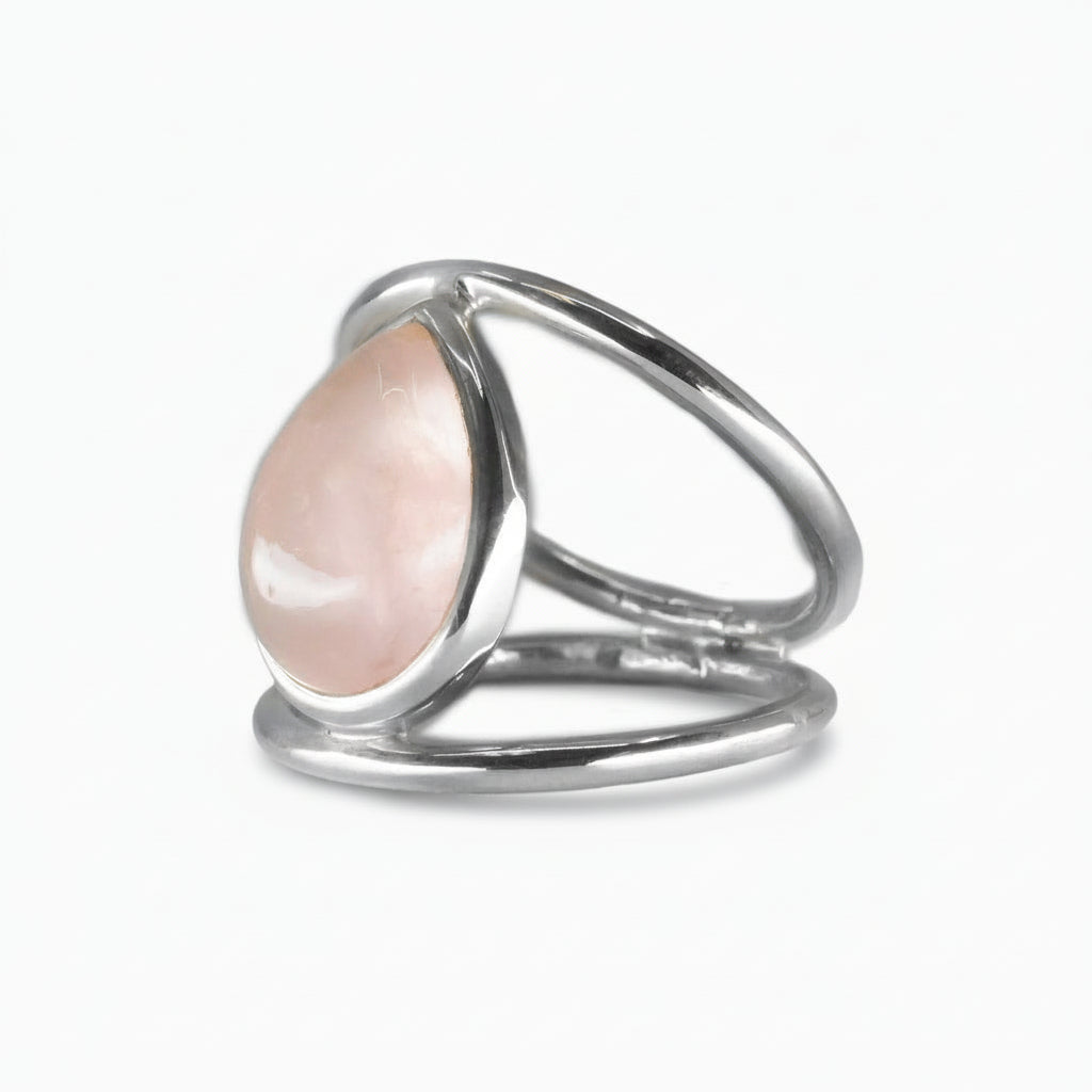 Teardrop Rose Quartz cabochon ring set in an open sterling silver band, featuring soft pink tones and a smooth, polished surface | MADE IN EARTH USA
