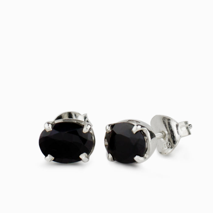 Oval faceted Black Onyx gemstones in polished sterling silver claw-set stud earrings.