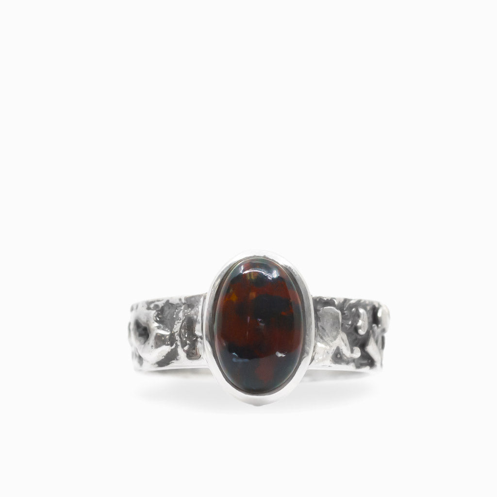 Oval Bloodstone cabochon in a polished bezel on a textured 925 sterling silver ring.
