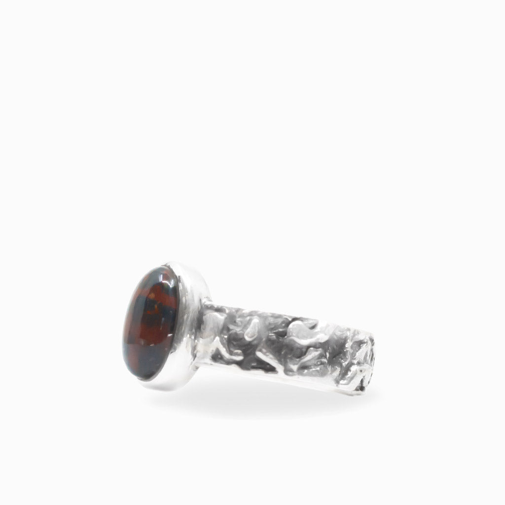 Oval Bloodstone cabochon in a polished bezel on a textured 925 sterling silver ring.