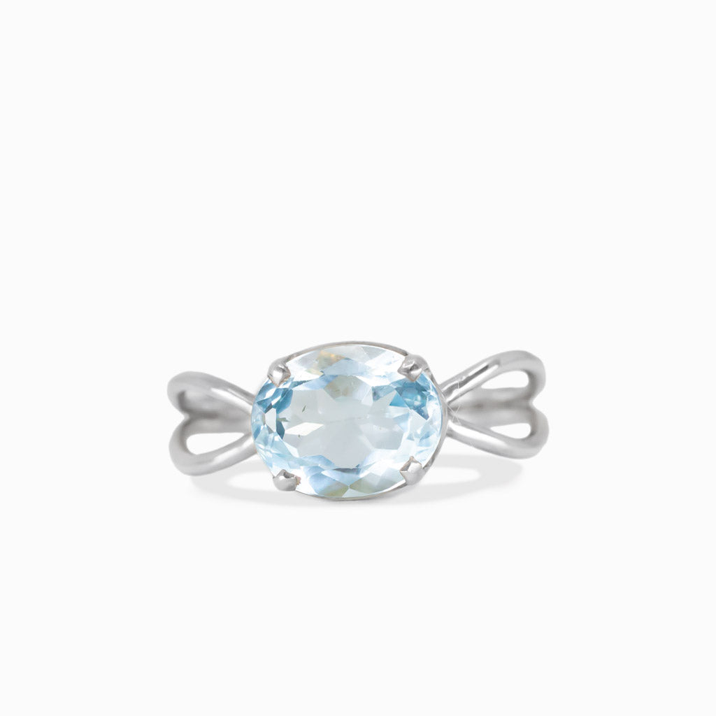 Faceted oval blue topaz claw ring in sterling silver