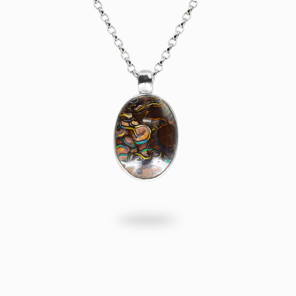 Oval Boulder Opal pendant with natural brown matrix and colorful blue, green, and orange opal flashes set in sterling silver.