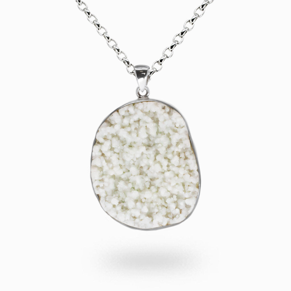 Freeform hoar frost quartz druzy pendant with snow-like white crystal texture set in a sterling silver bezel on a silver chain.