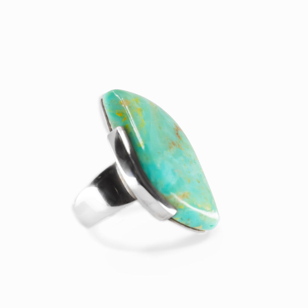 Campo Frio Turquoise freeform cabochon ring in polished sterling silver with aqua blue coloring and natural golden-brown matrix.
