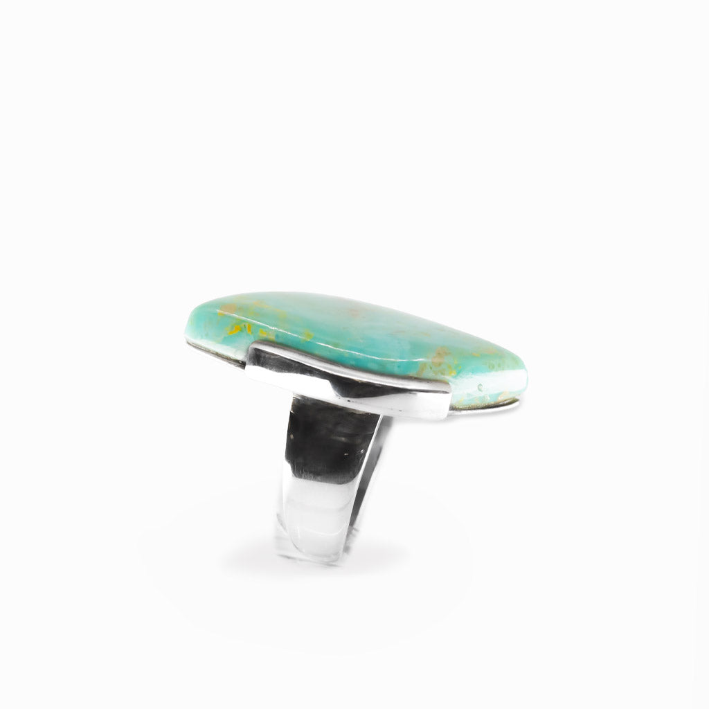 Campo Frio Turquoise freeform cabochon ring in polished sterling silver with aqua blue coloring and natural golden-brown matrix.