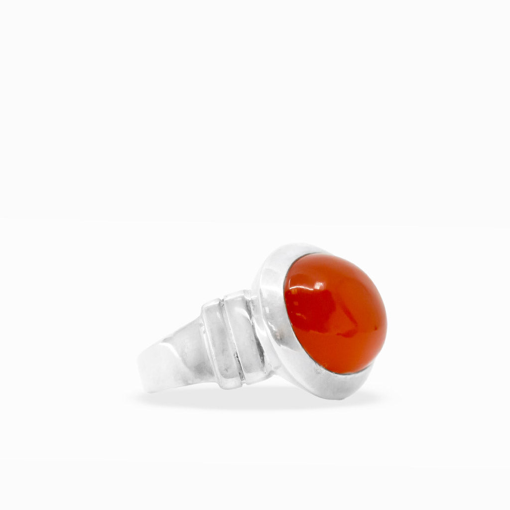 Bright orange-red oval Carnelian cabochon ring with smooth polished surface and wide sterling silver bezel setting.