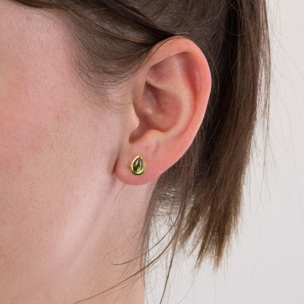 Peridot stud earrings on model